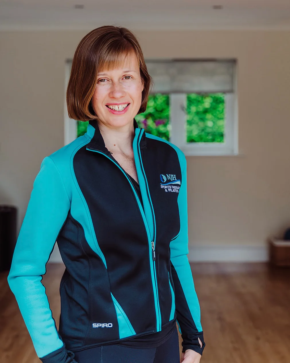 Natasha Hadland in NJH kit, standing in the studio
